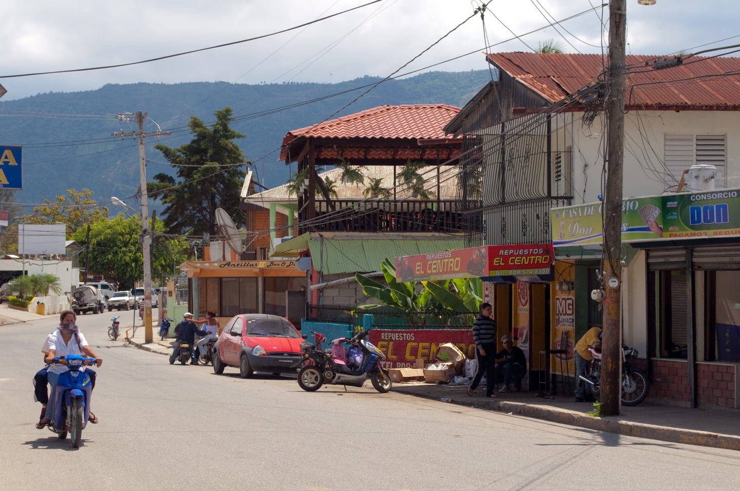 motorbike on street lined with shops
