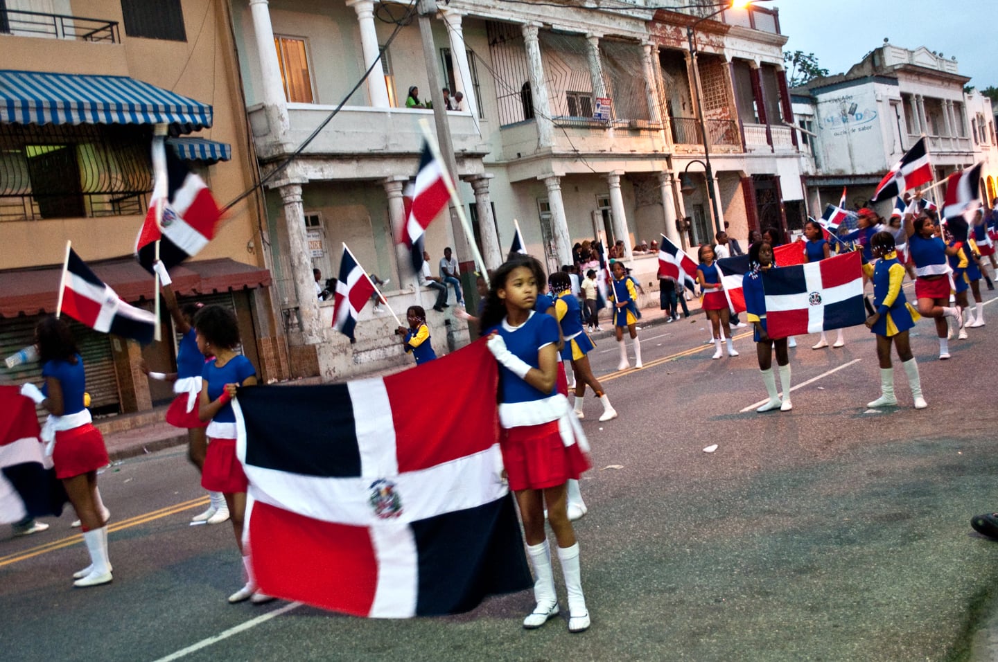 girl holding flag on street