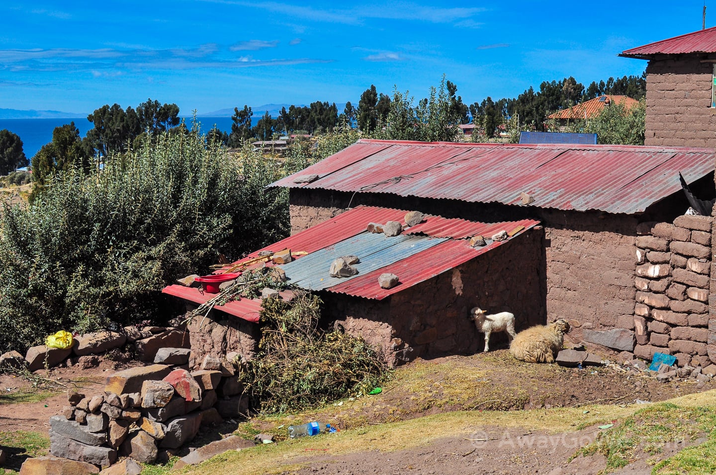 large rocks hold metal roofing on Lake Titicaca