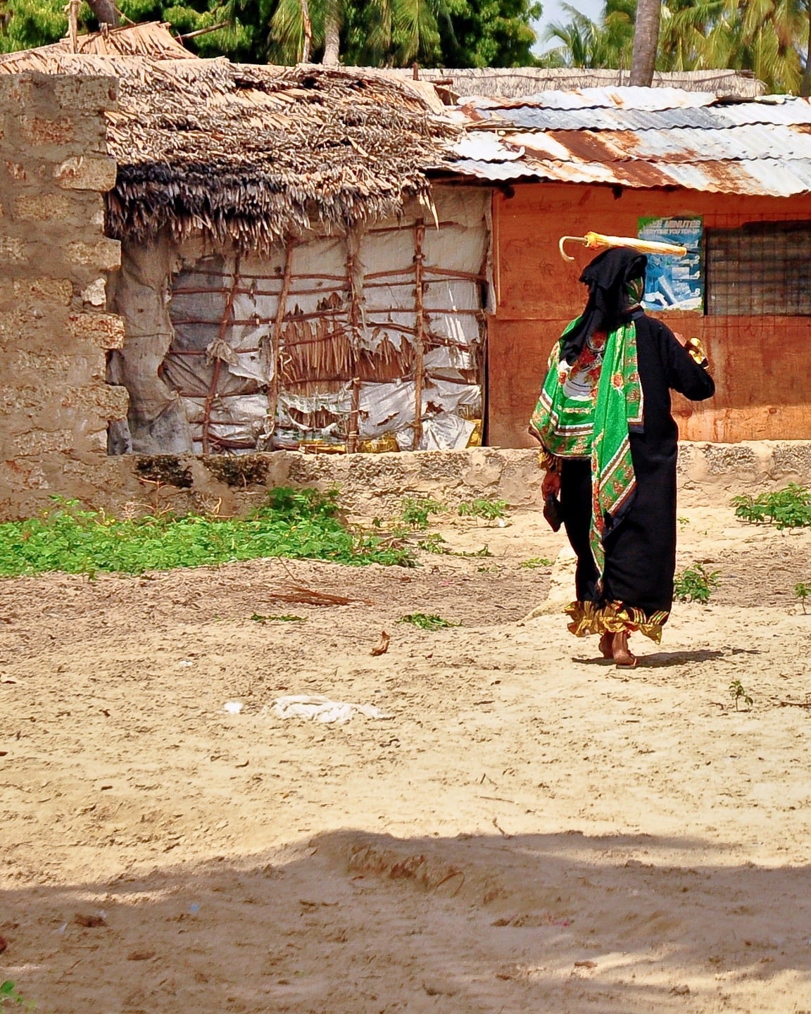 woman walking with umbrella Shela Lamu