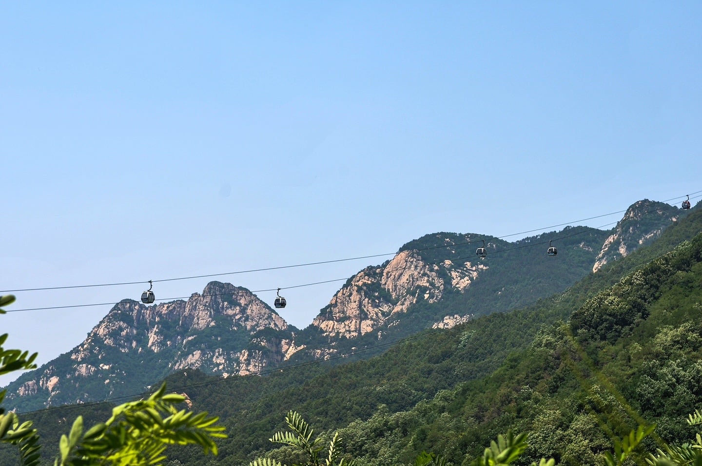 Cable cars going up a mountain