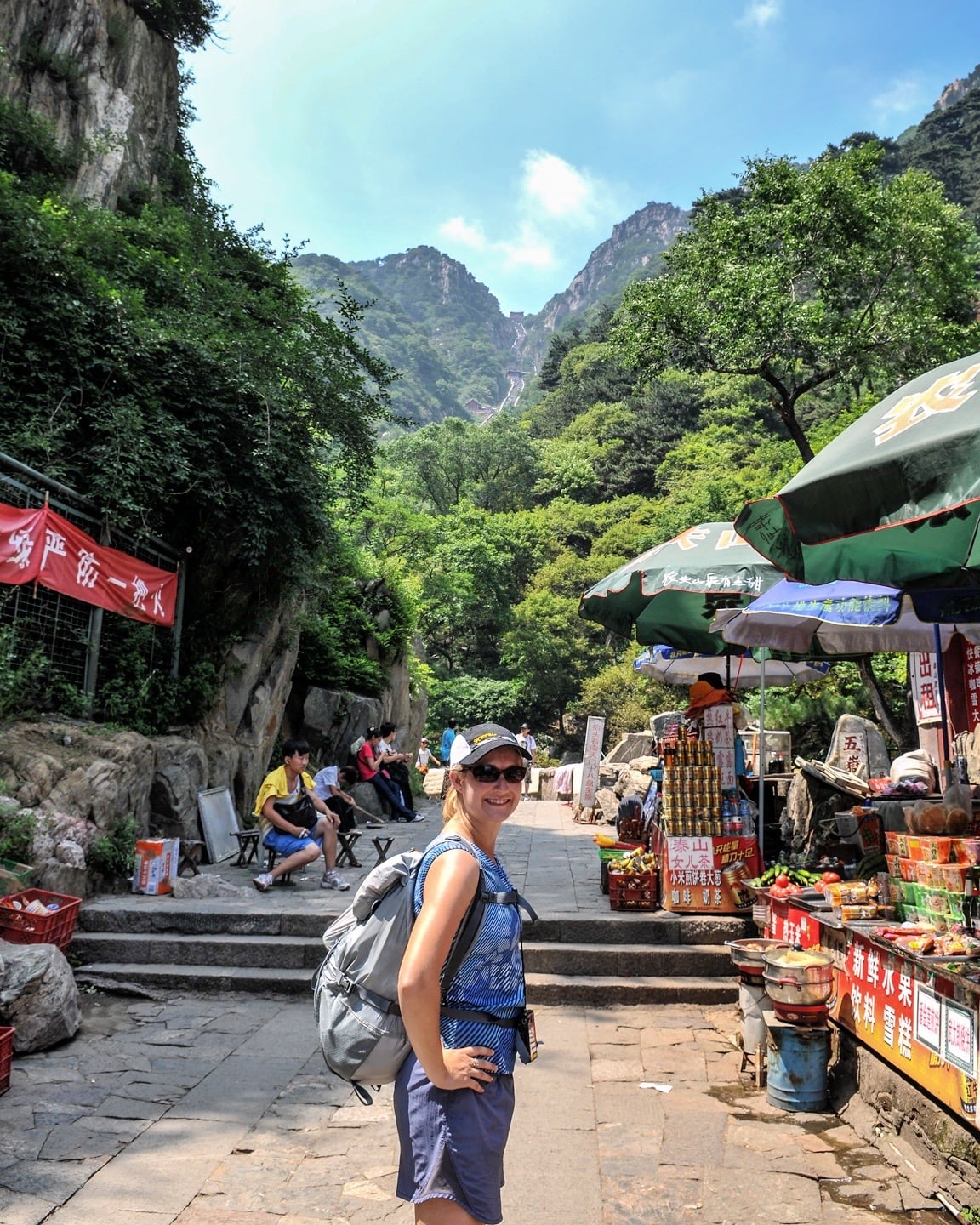 woman standing in front of stairs leading to Mount Tai