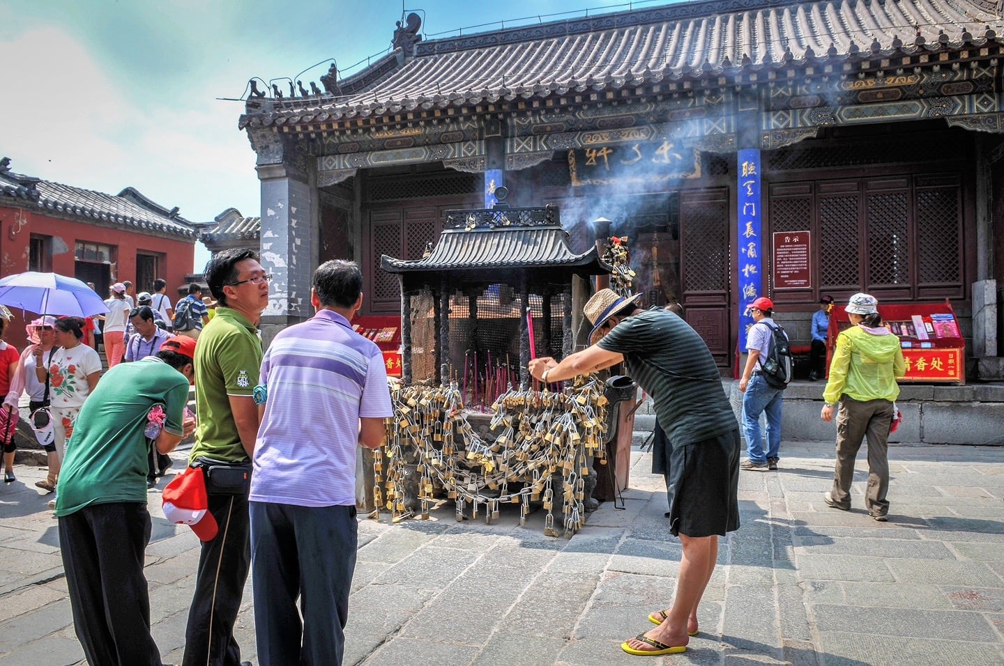 Man giving an offering at a temple on Mount Tai