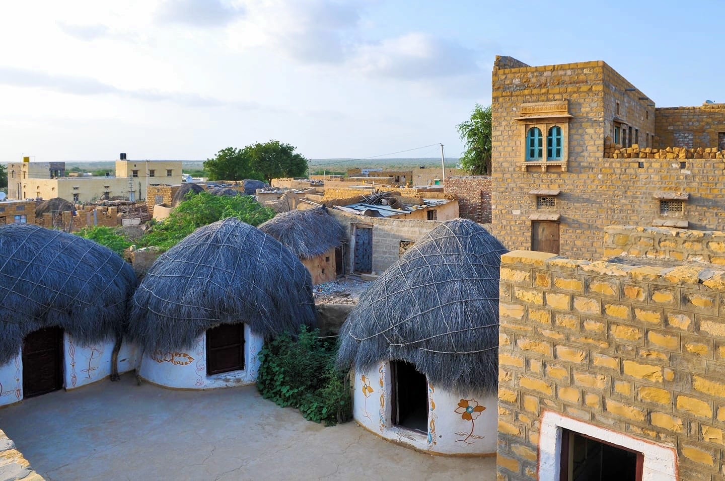 thatch roof mud huts in Khuri Village India