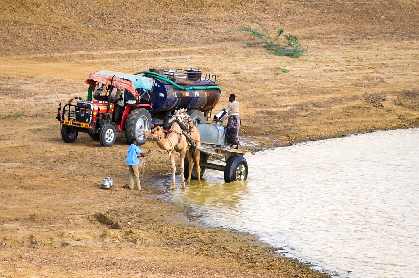 people near Jaisalmer getting water from a reservoir