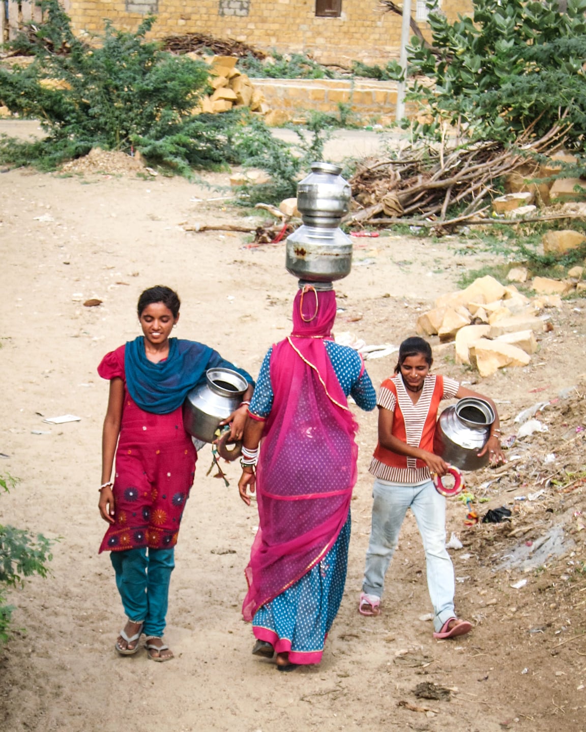woman transporting water from well in Khuri Village