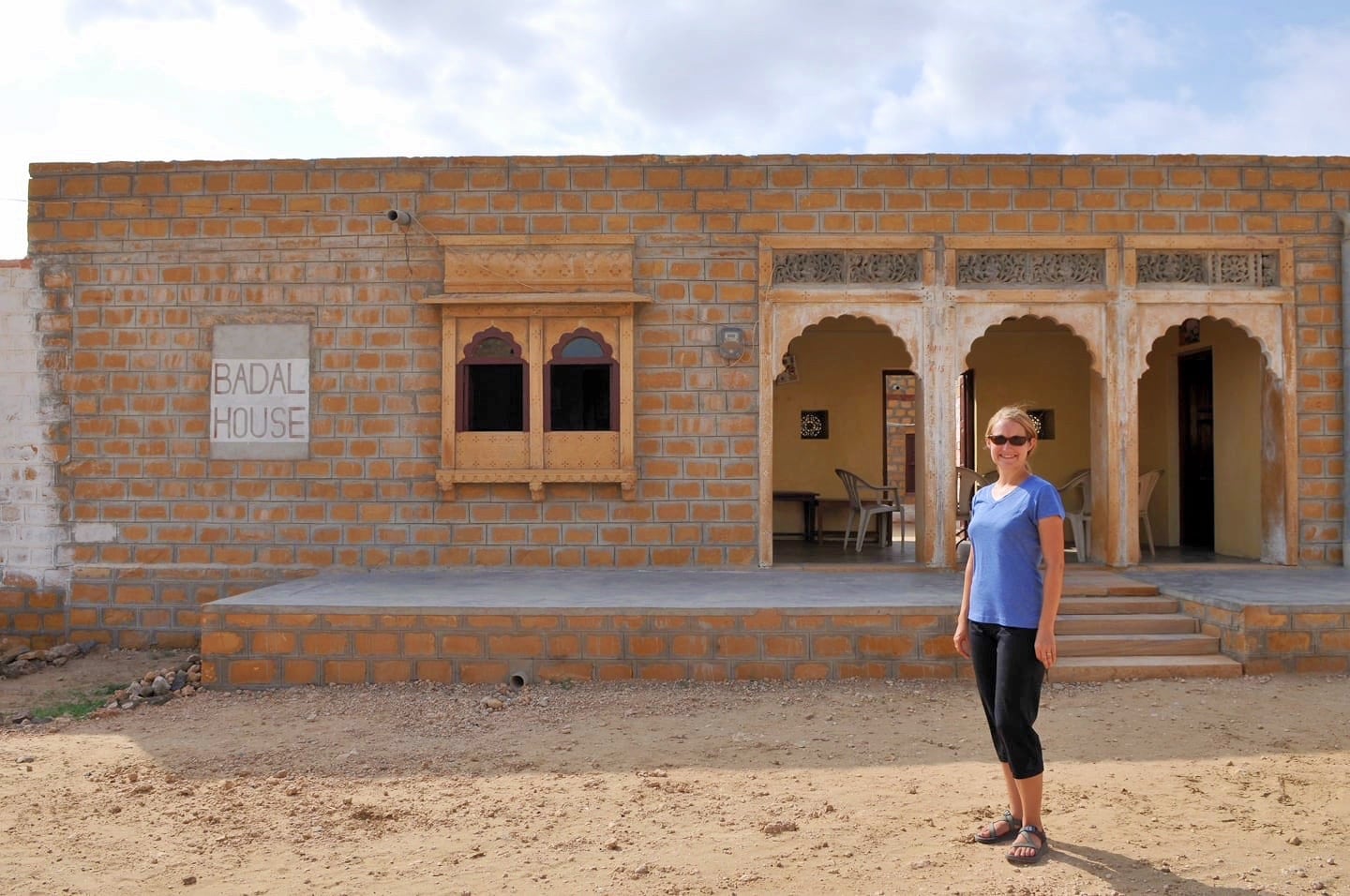 woman in front of Badal House homestay Khuri Village