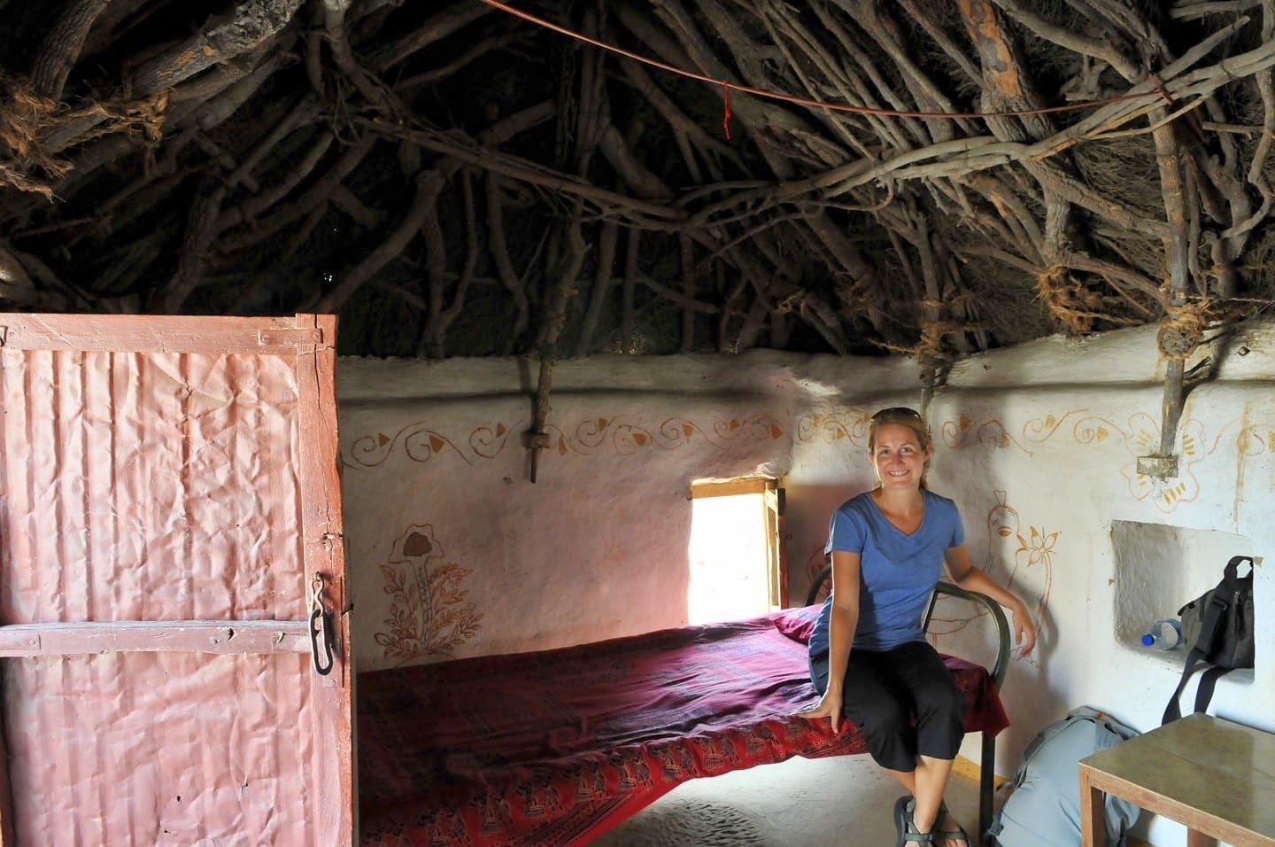 woman in small mud house in Khuri Village India