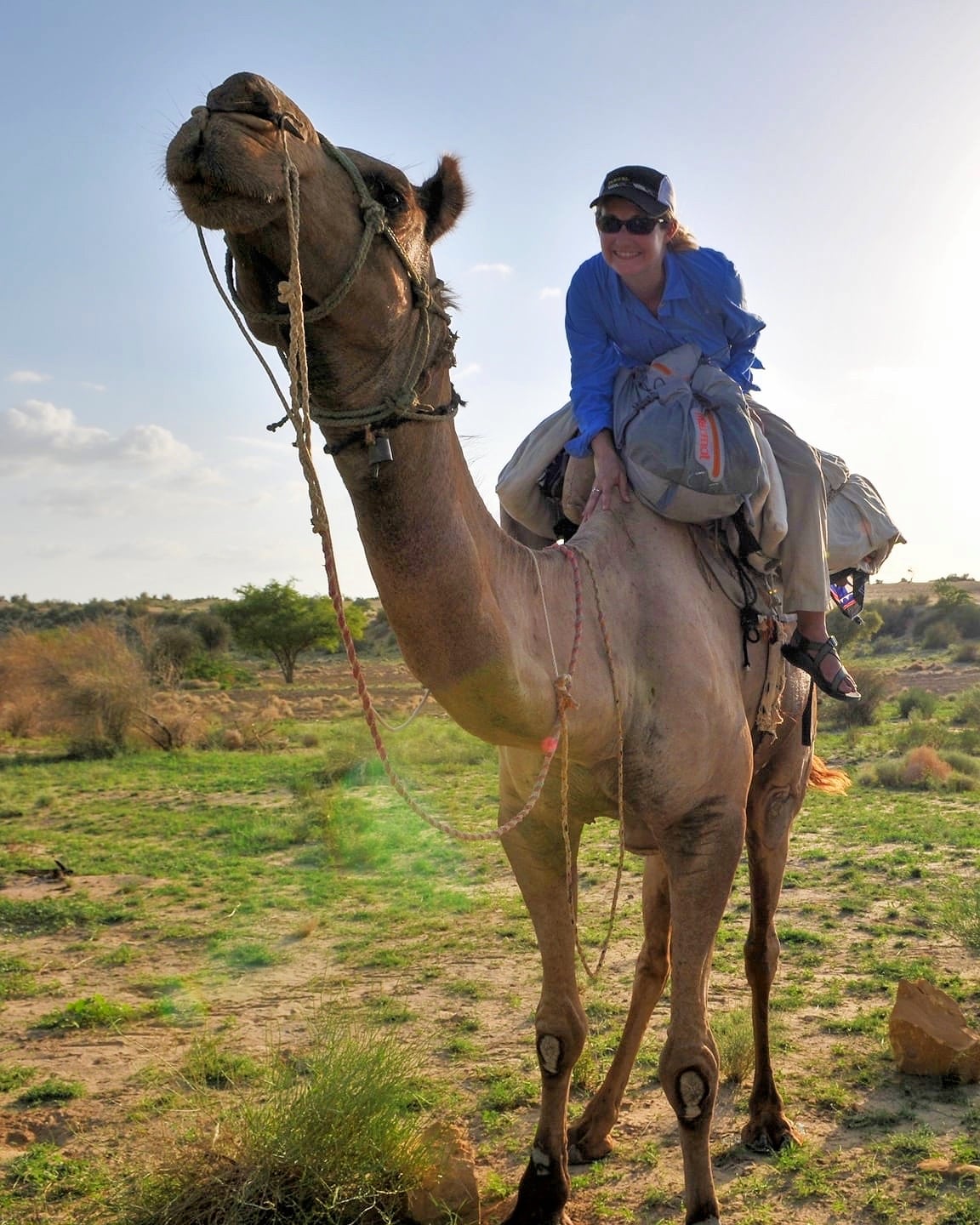 woman on camel in desert in Rajasthan