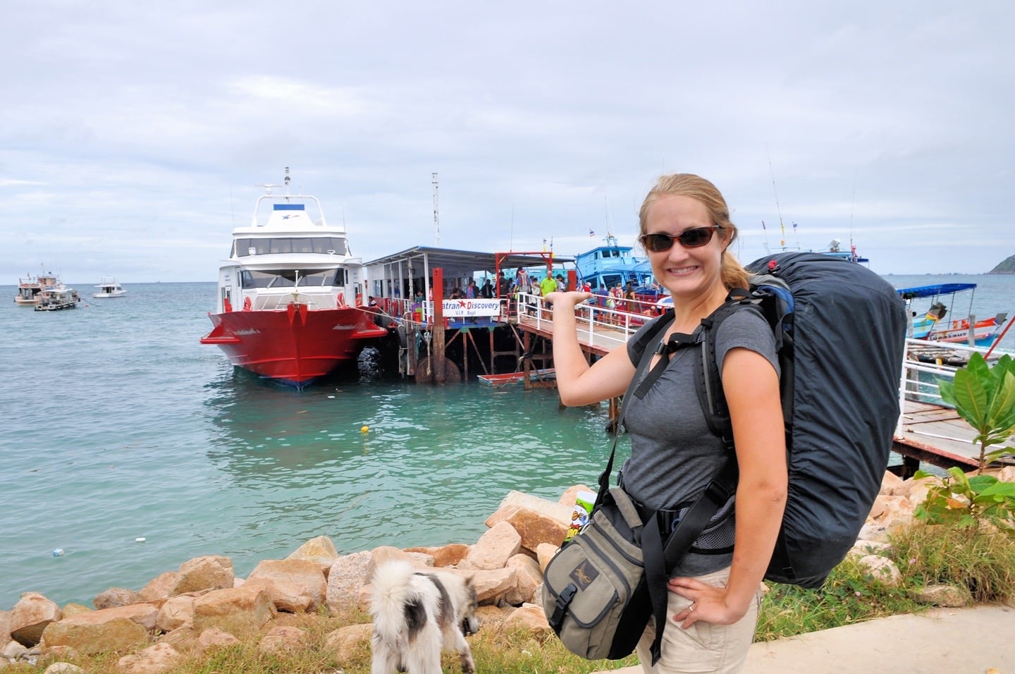 woman with backpack near ship