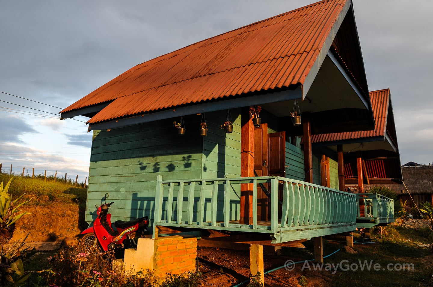 motorbike near wooden bungalow on thakhek loop in laos