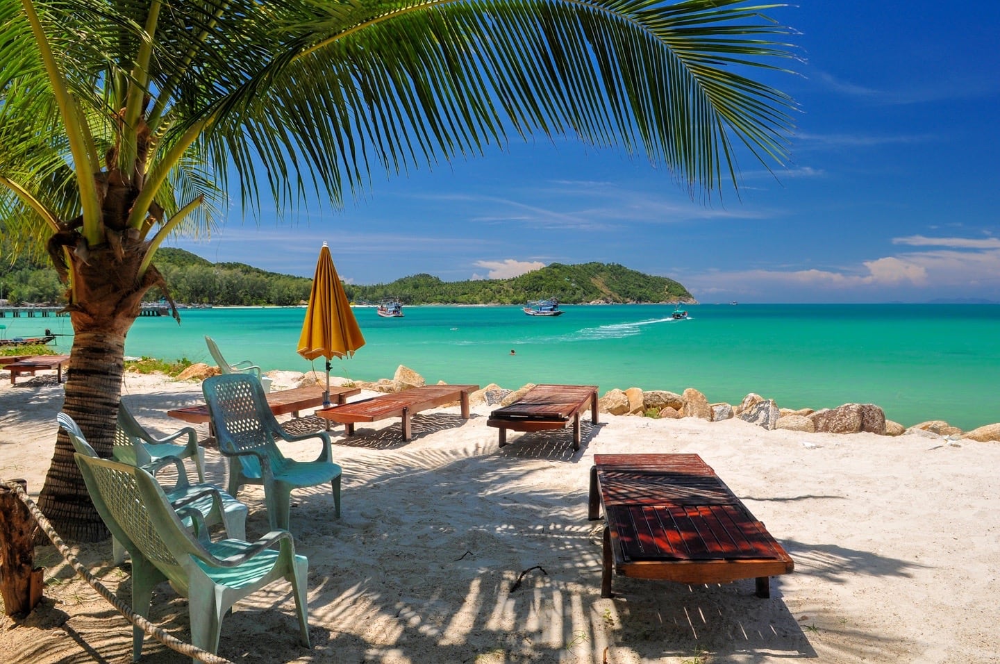 palms on beach and turquoise water Thailand