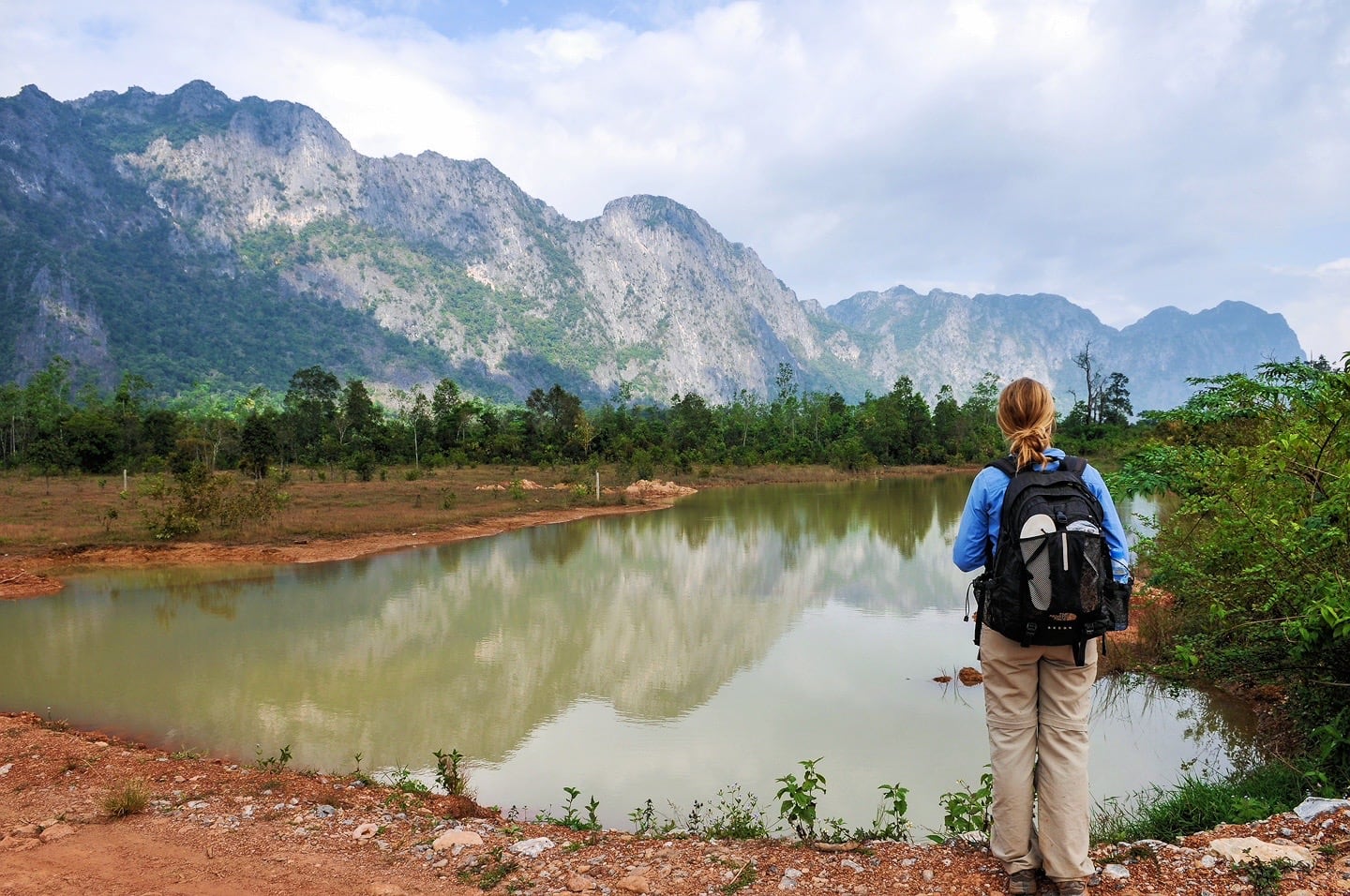 karst peeks and woman along the Thakhek Loop