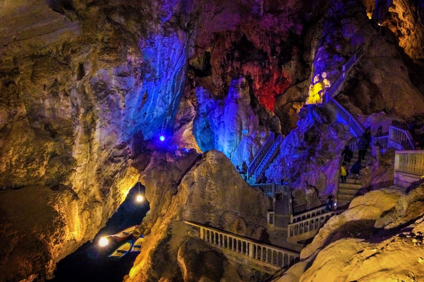 inside of cave with boats along the Thakhek Loop