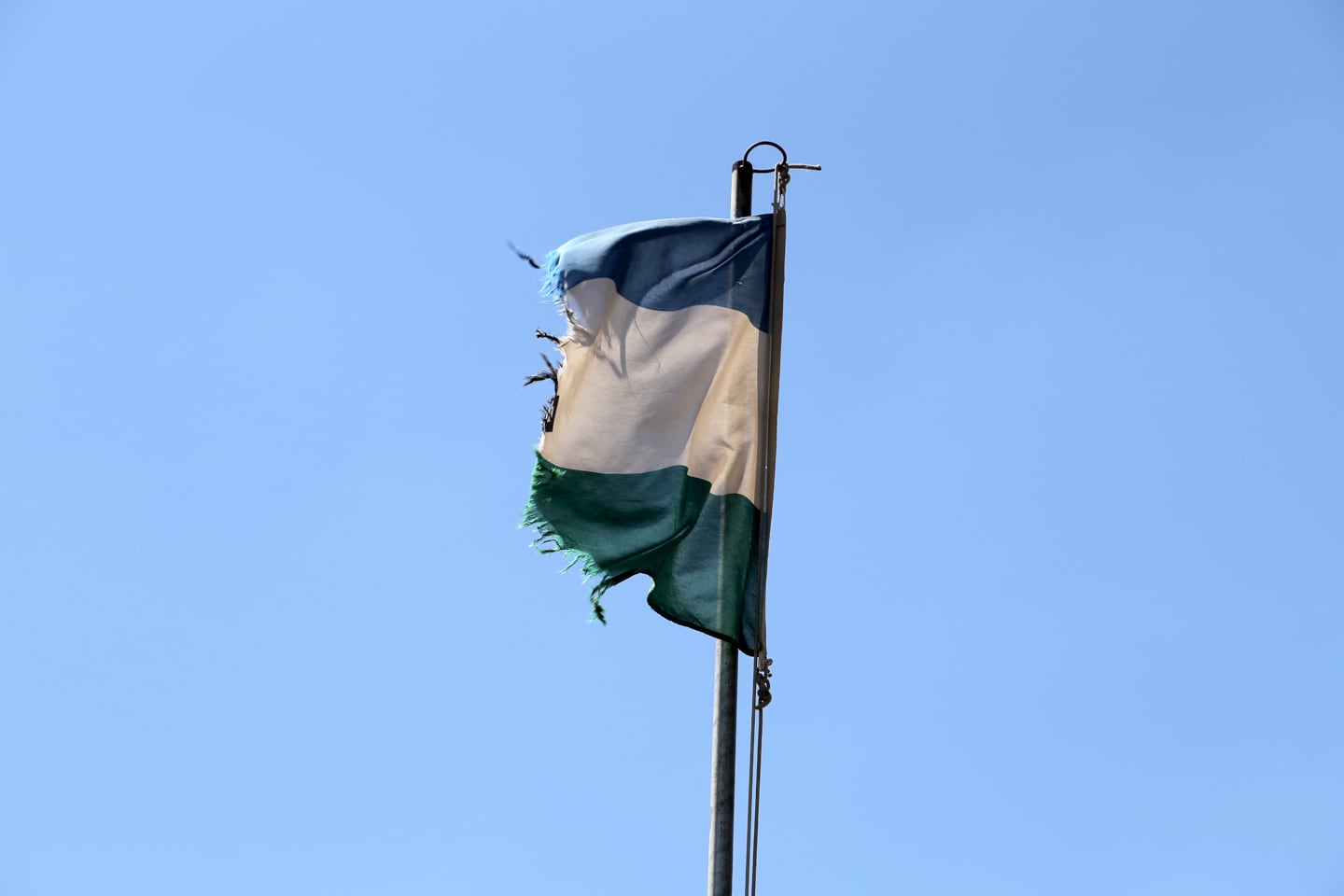 tattered Lesotho flag at border