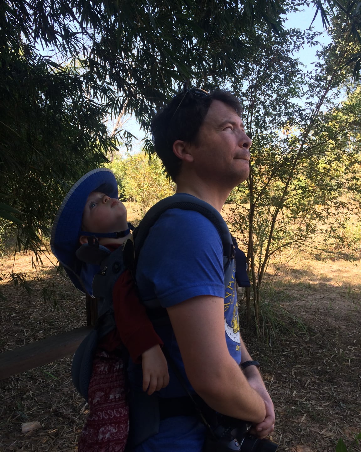 man and baby looking up