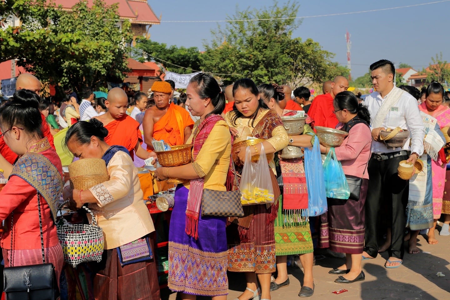 devotees waiting to give alms to monks