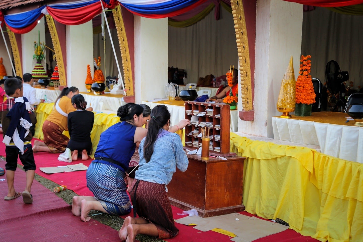 getting fortune read at Buddhist temple in Laos