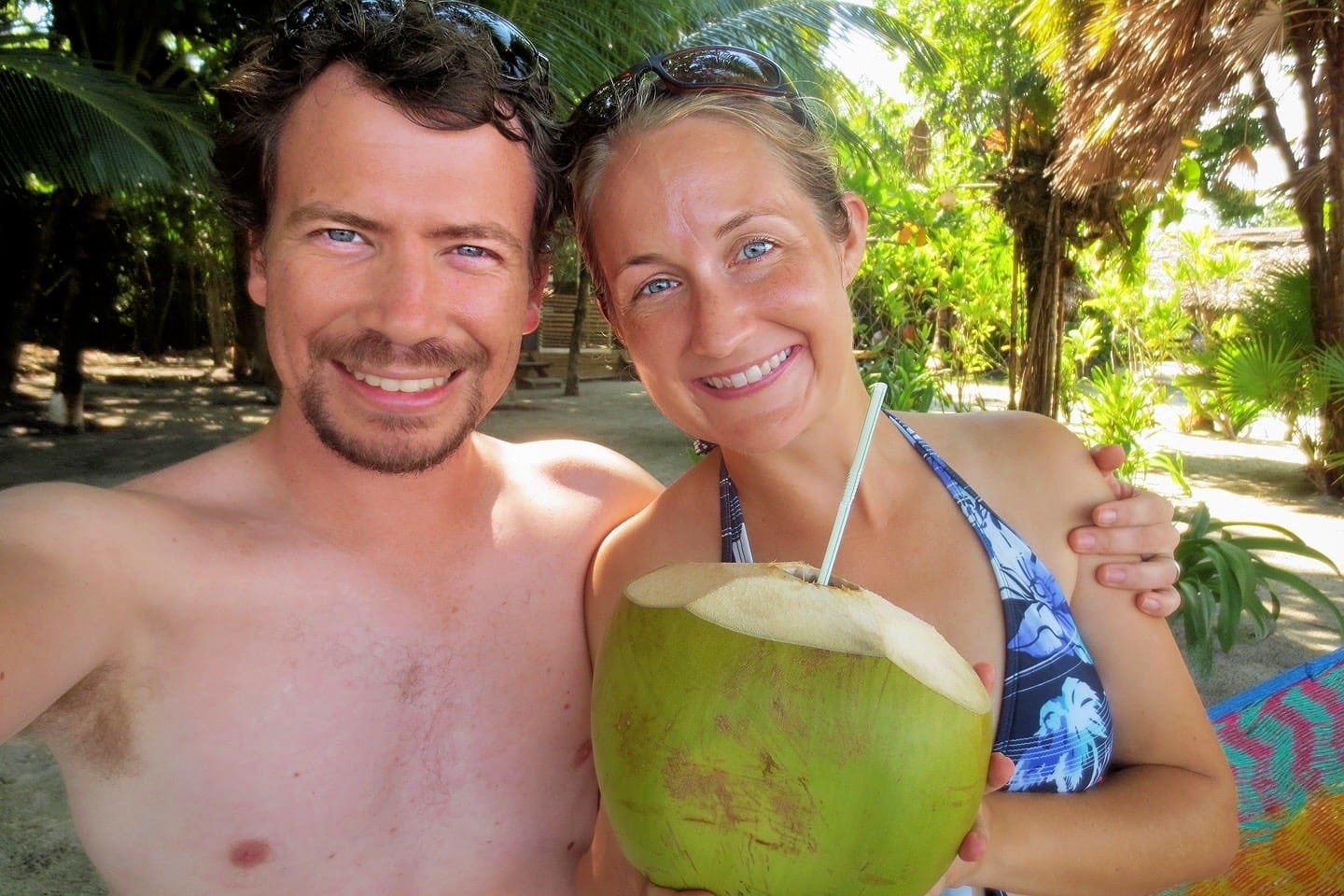 two people drinking a coconut