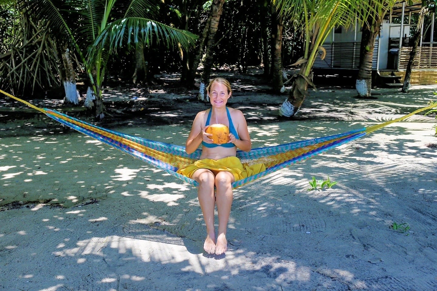 woman with coconut on hammock