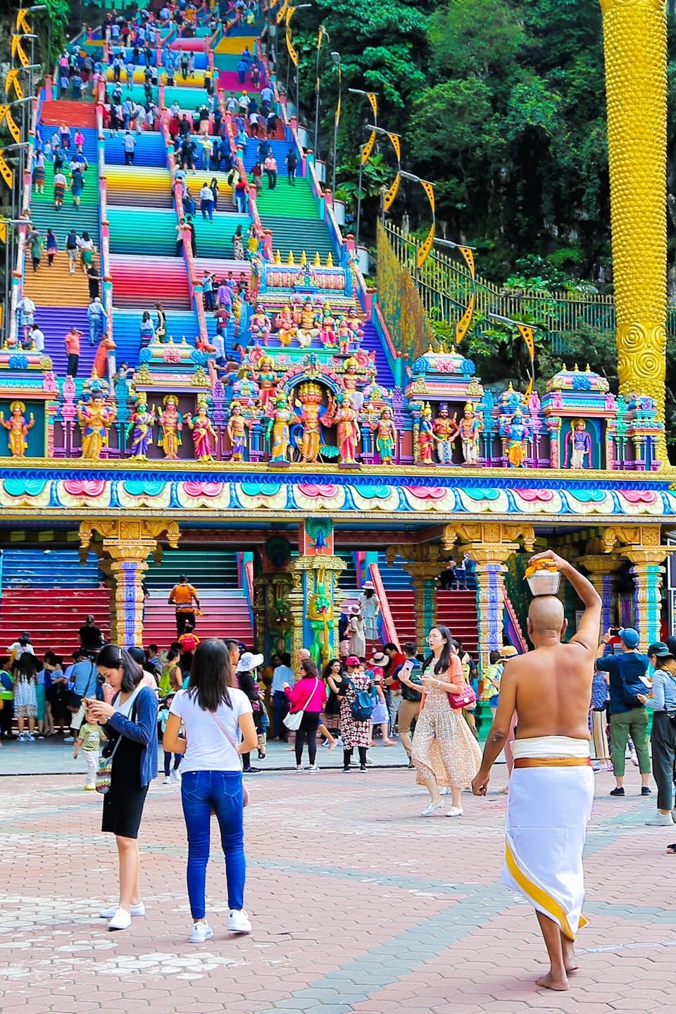 KL Sentral to Batu Caves DIY day trip man with offering on head