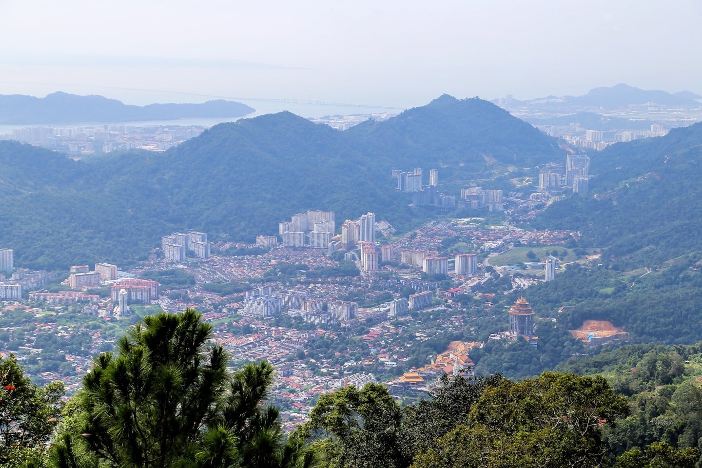 aerial view of valley with buildings and forested hills