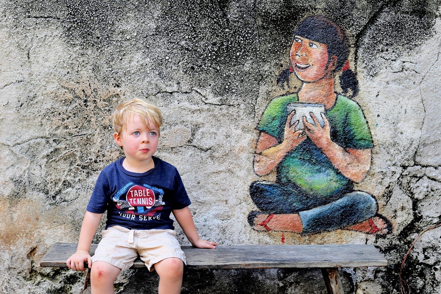 George Town Penang Street Art sitting on bench with bowl