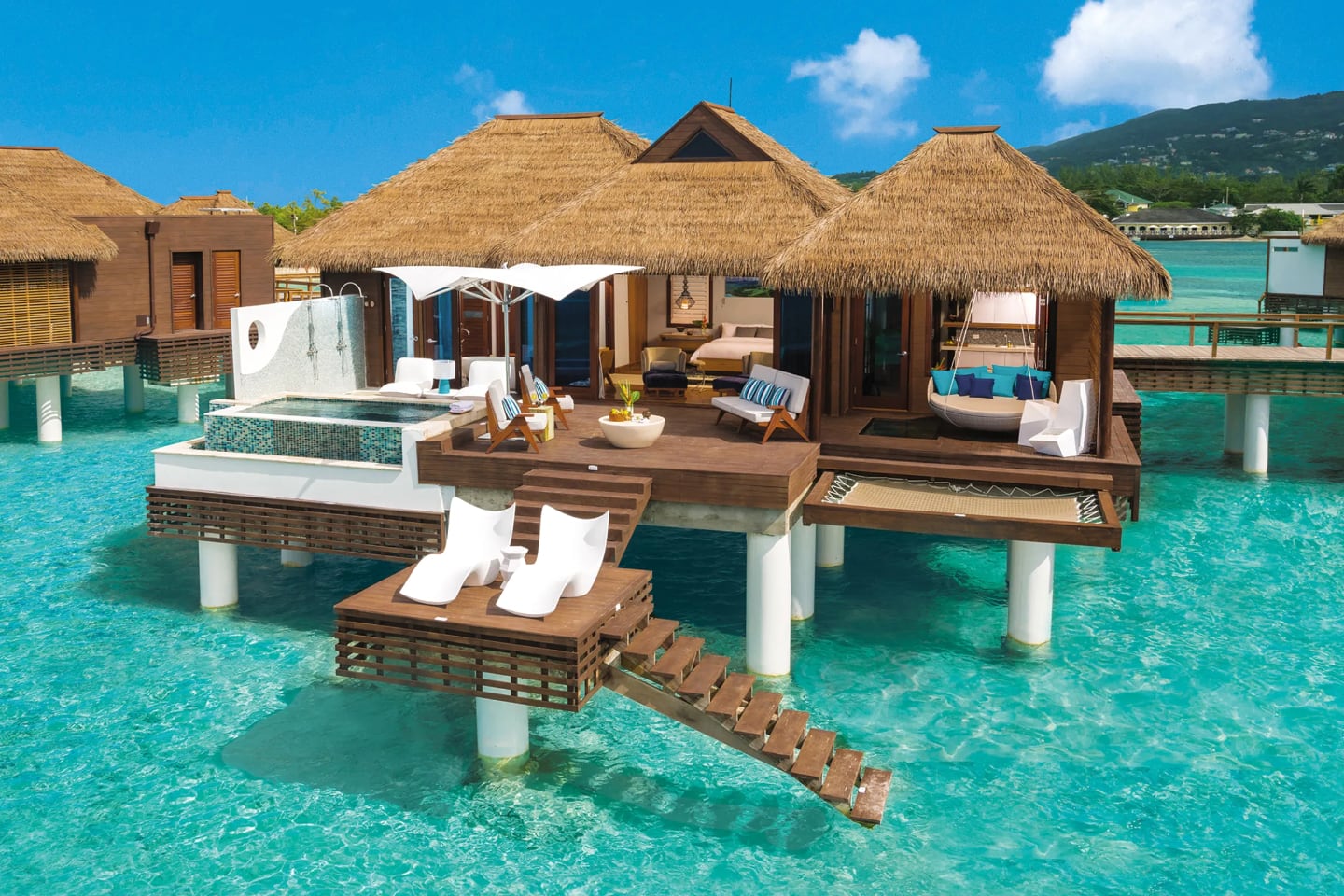 caption-right best overwater bungalows in the Caribbean surrounded by clear waters