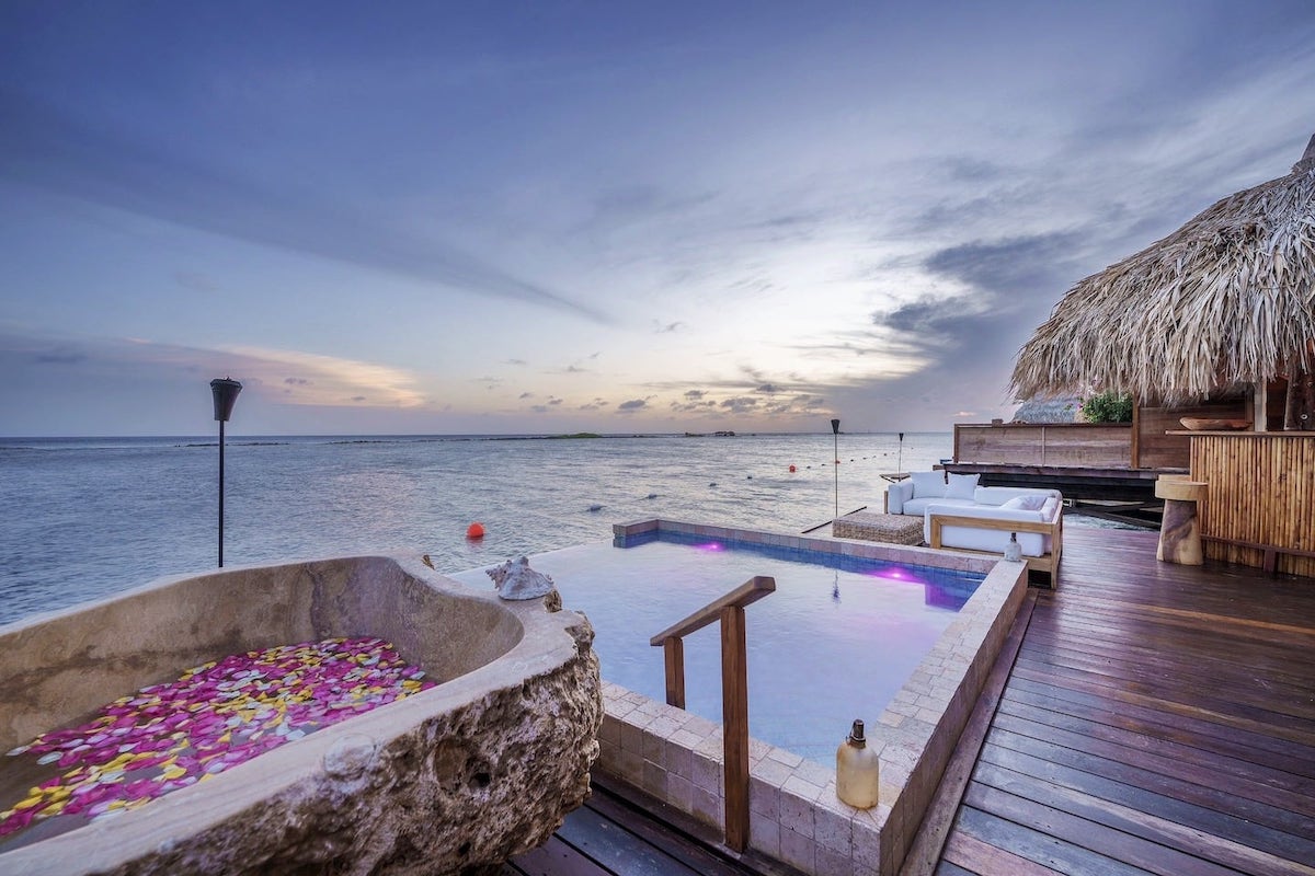 infinity pool at sunrise in overwater bungalows in the Caribbean