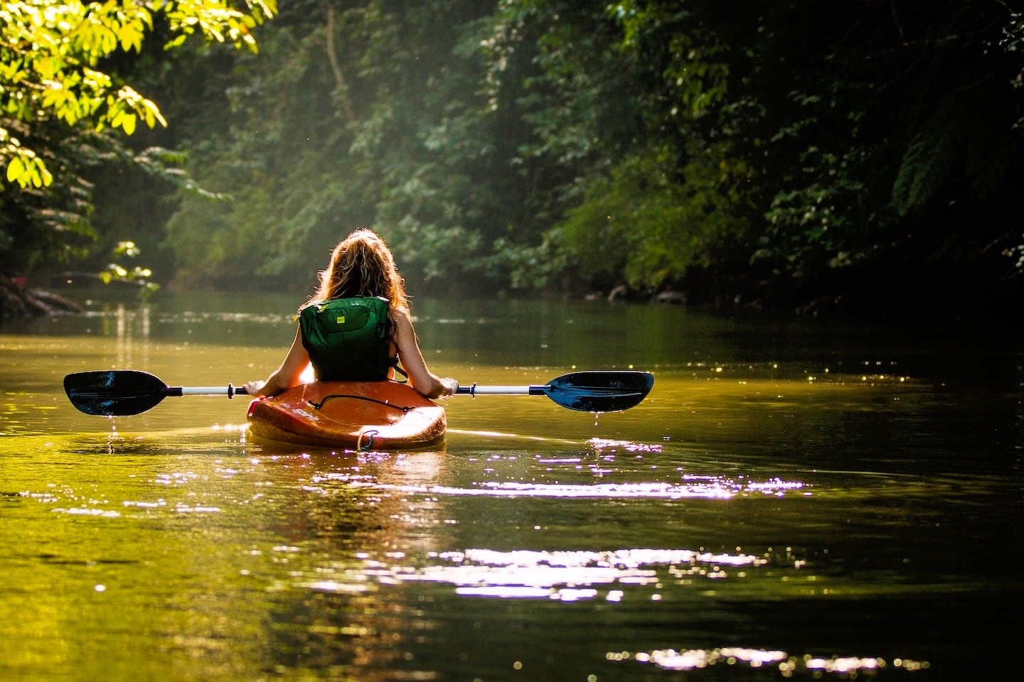 woman kayaking on river