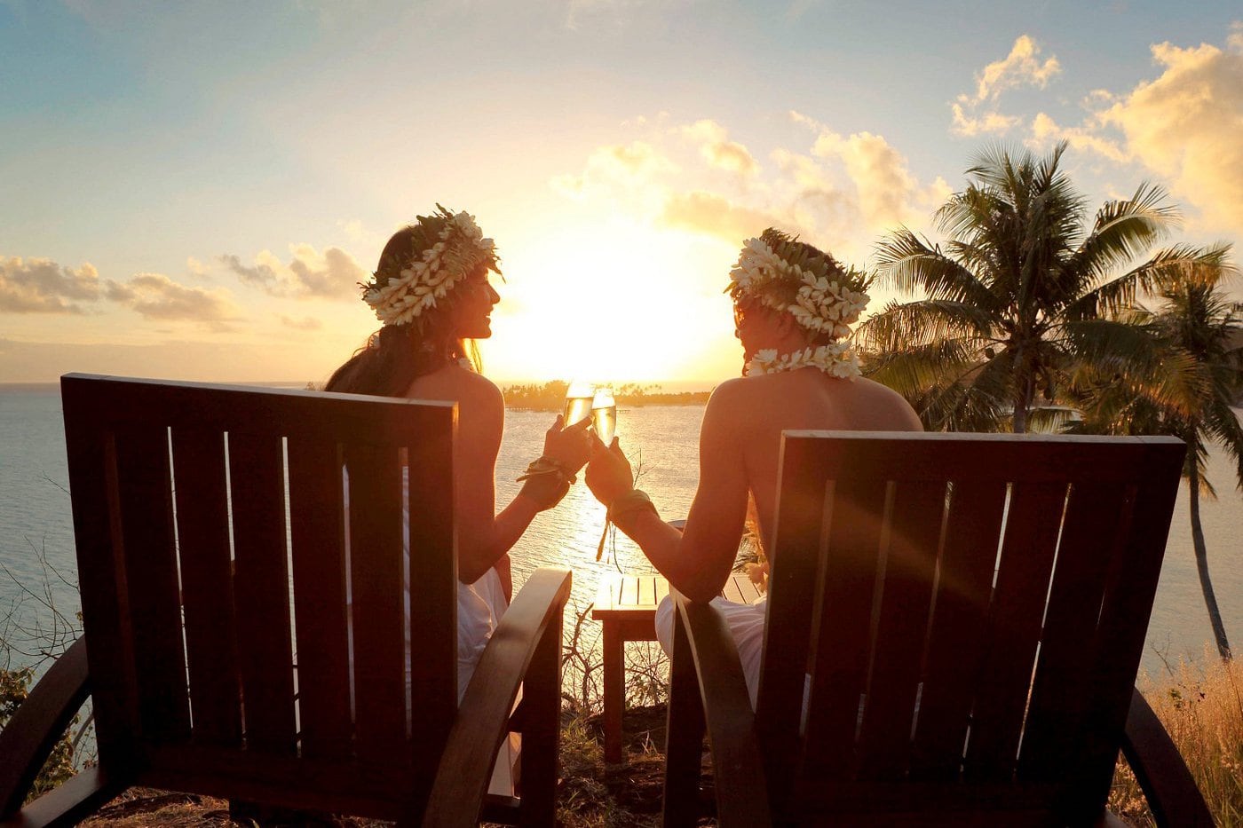 couple toasting beach sunset
