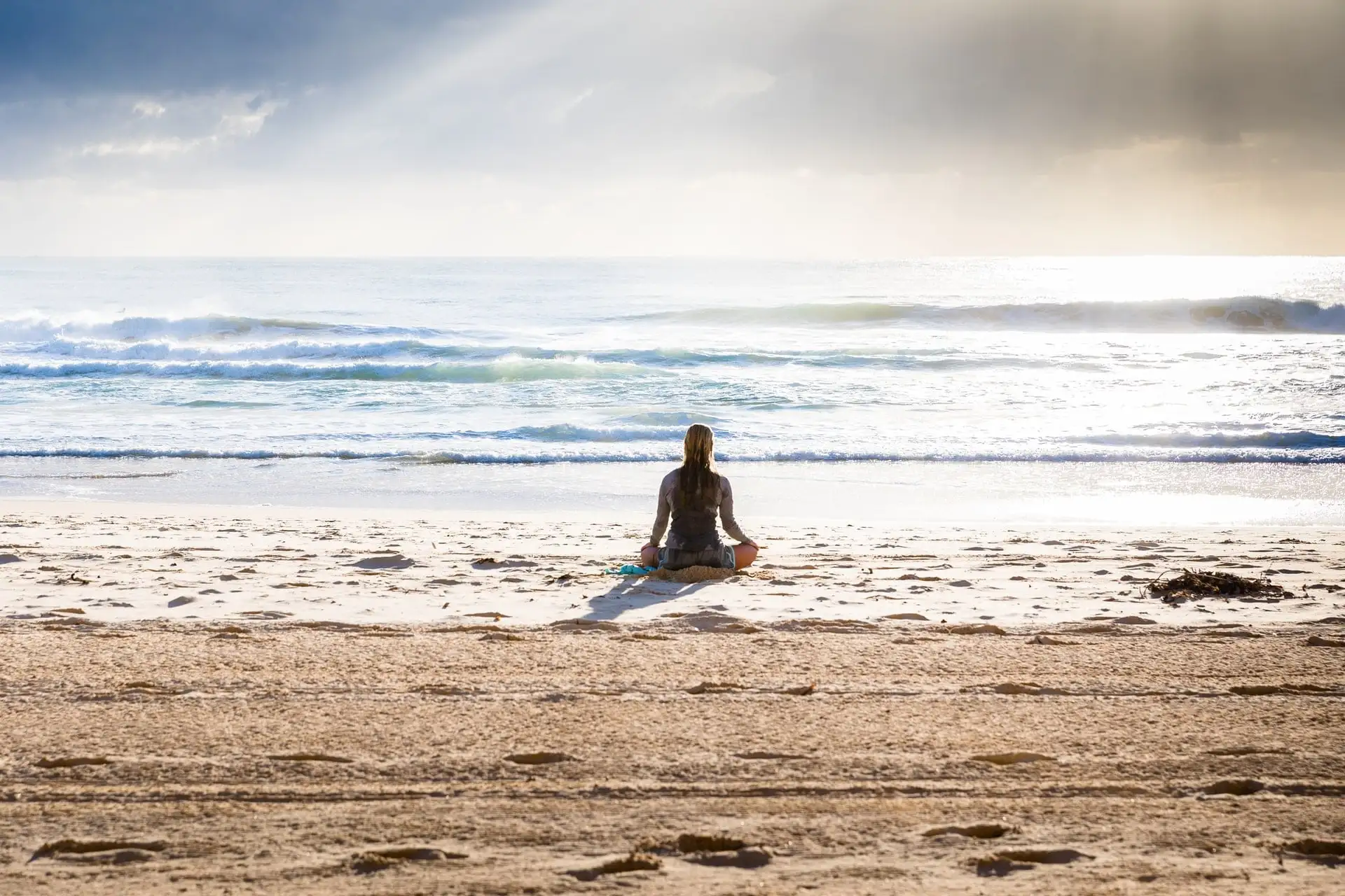 woman on beach yoga retreats in Mexico