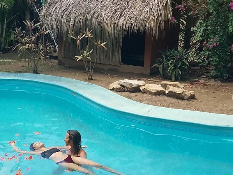 woman floating in a pool yoga retreats in Mexico