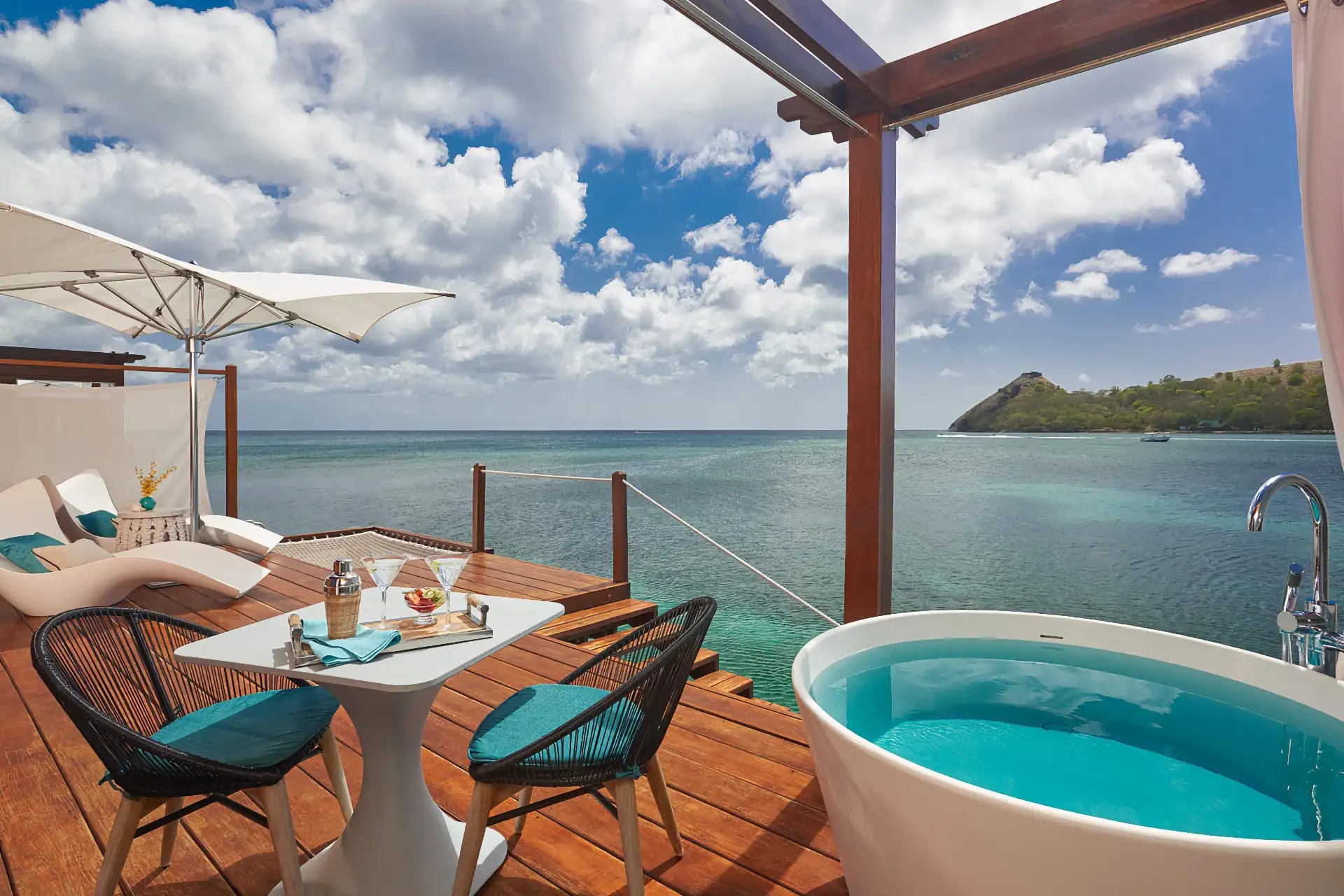 St Lucia honeymoon couple swinging over clear water