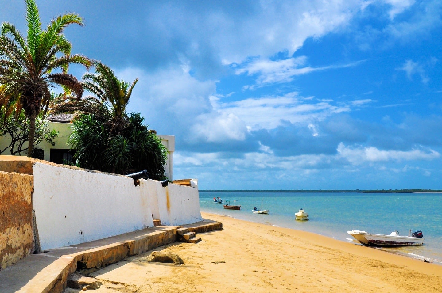 small beach and white wall with boat