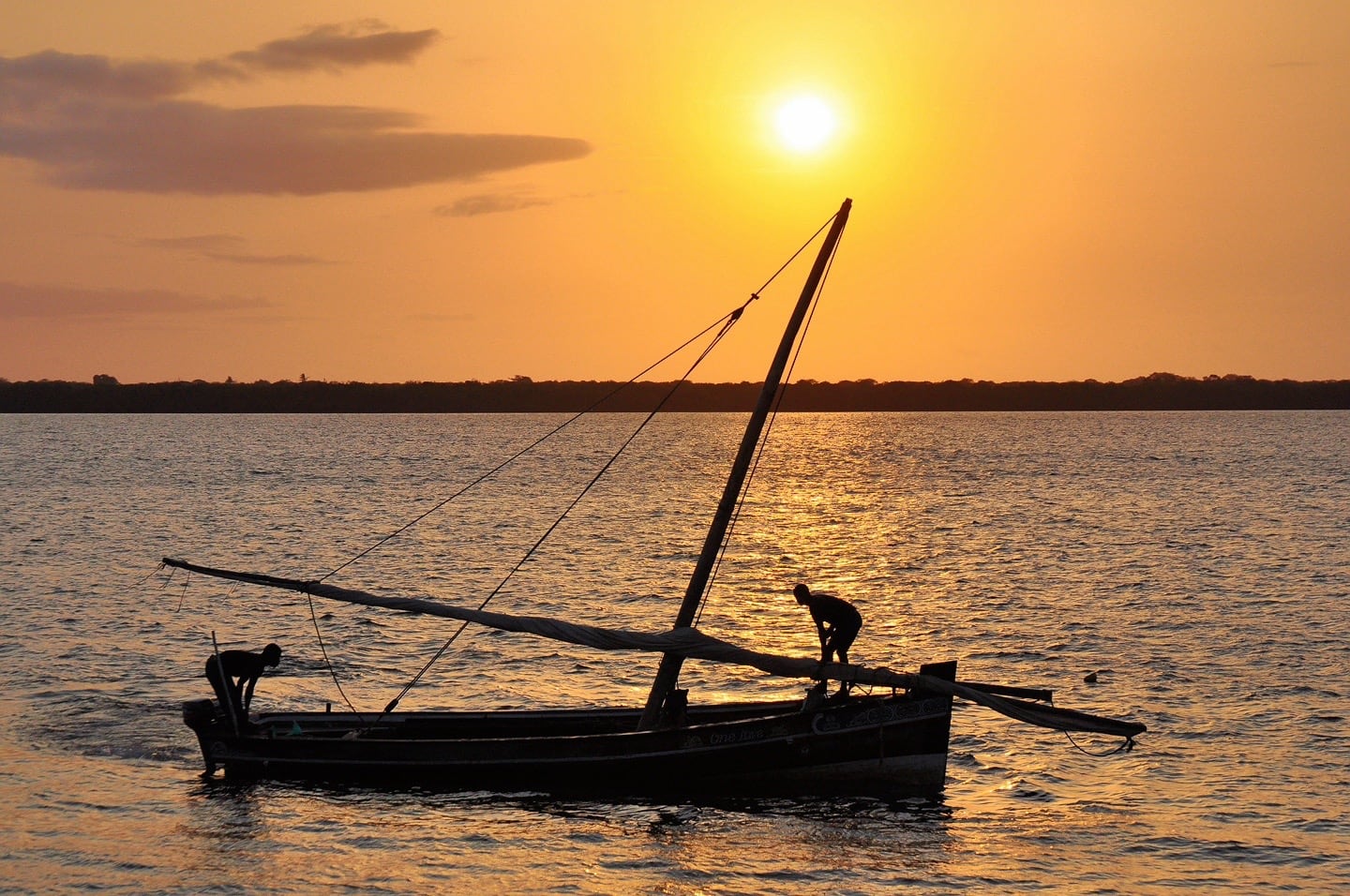 dhow sailboat and sunrise