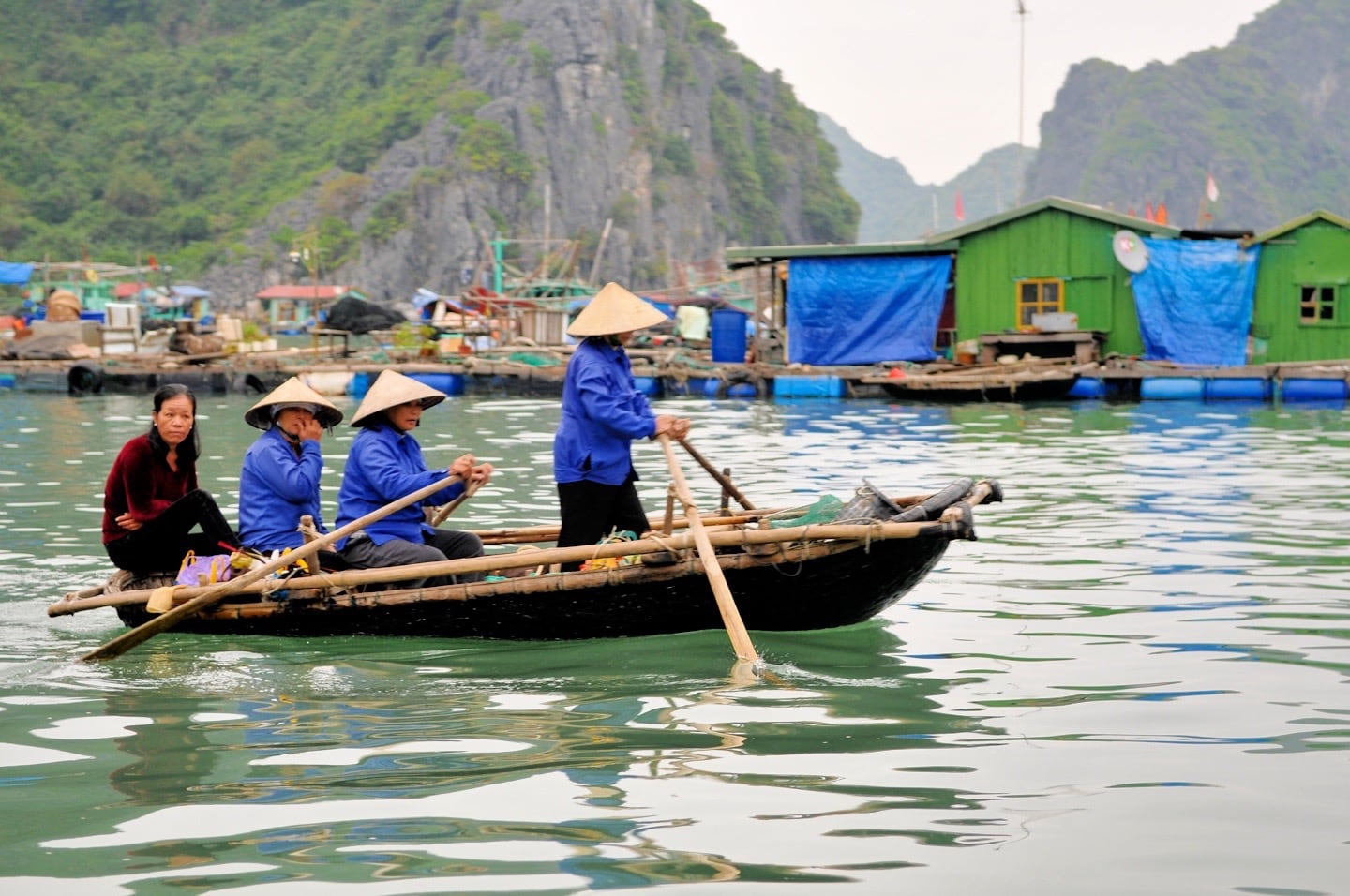 women rowing on fishing boat Halong Bay Vietnam
