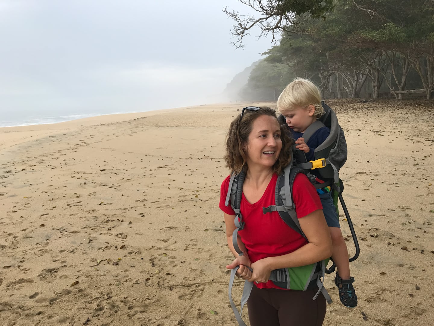 woman carrier child at beach