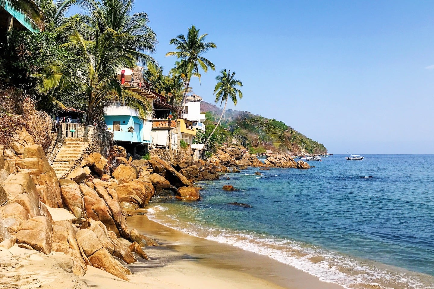 beach with houses perched on rocks