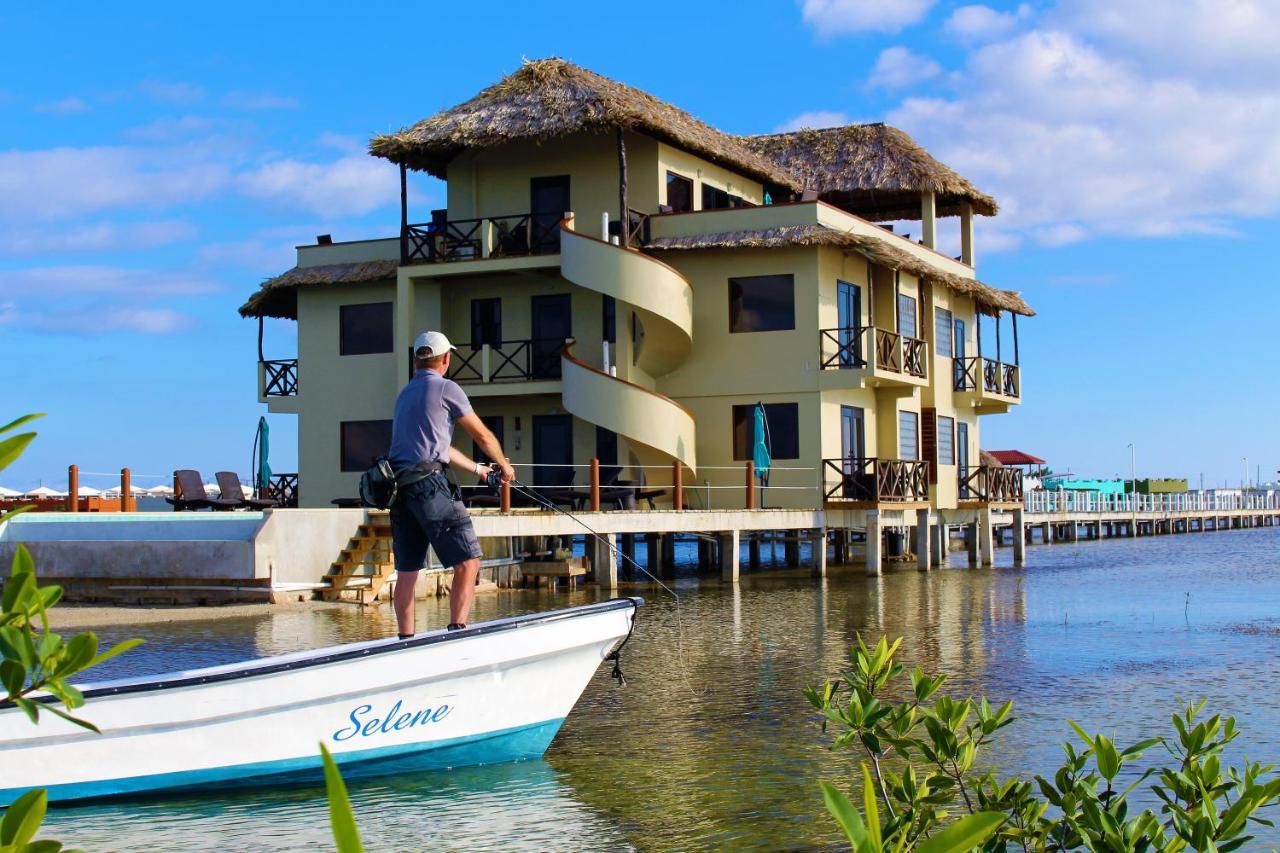 large villa over water with fisherman from boat