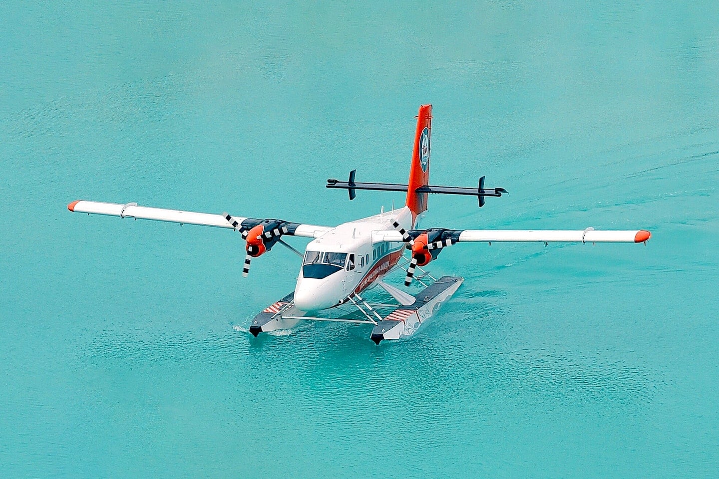 seaplane surrounded by turquoise water