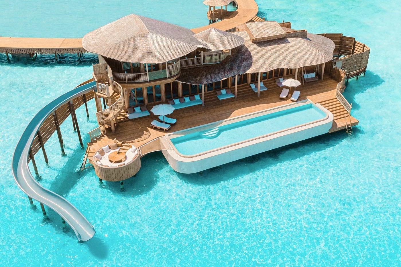 Soneva Jani Maldives luxury resort with pool and water slide surrounded by azure water