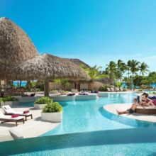 couple relaxing poolside at luxury adults only all inclusive Caribbean resorts