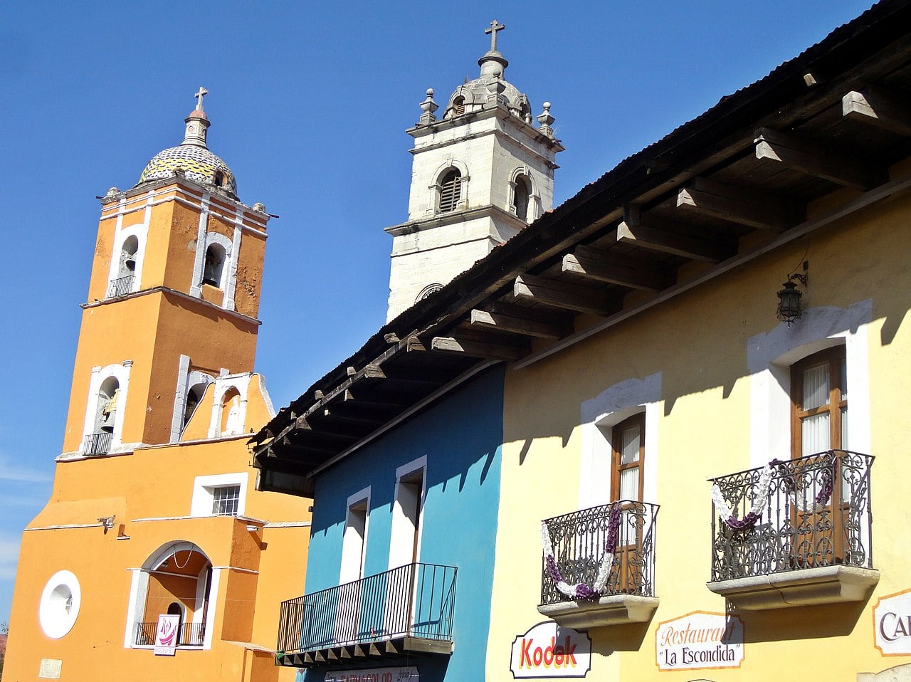 Church bell towers and colorful homes