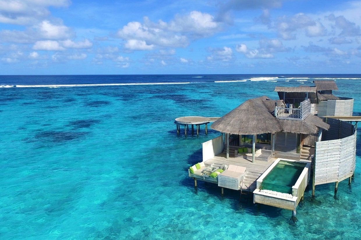 Maldives overwater bungalow surrounded by azure water
