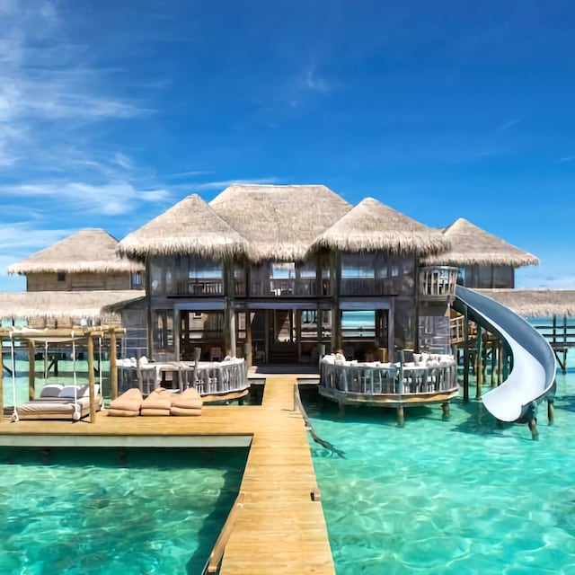 tropical island resort over water in the Maldives