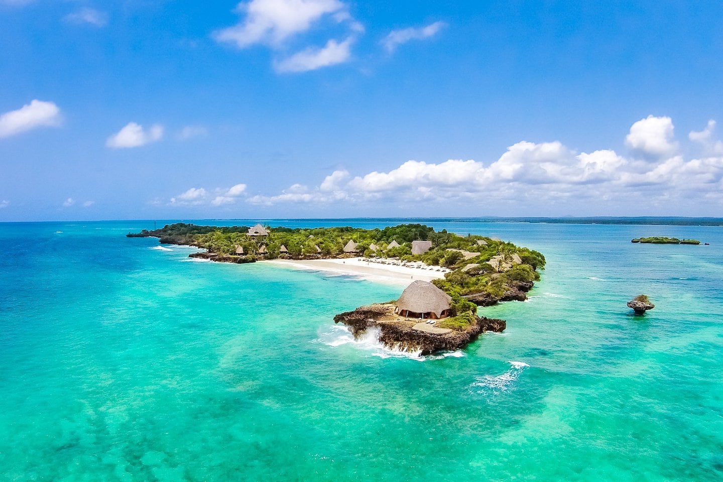 crescent island surrounded by emerald water