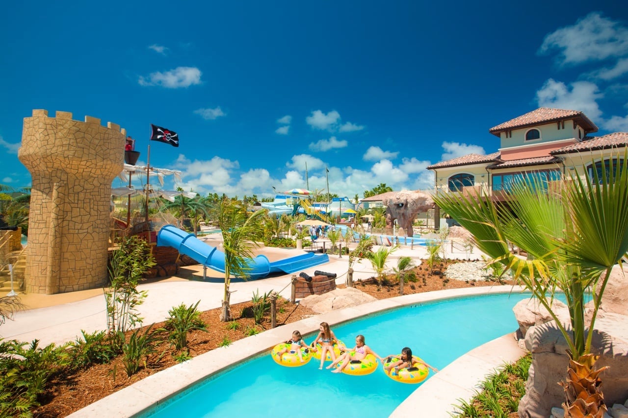 kids floating down lazy river at luxury beach resort