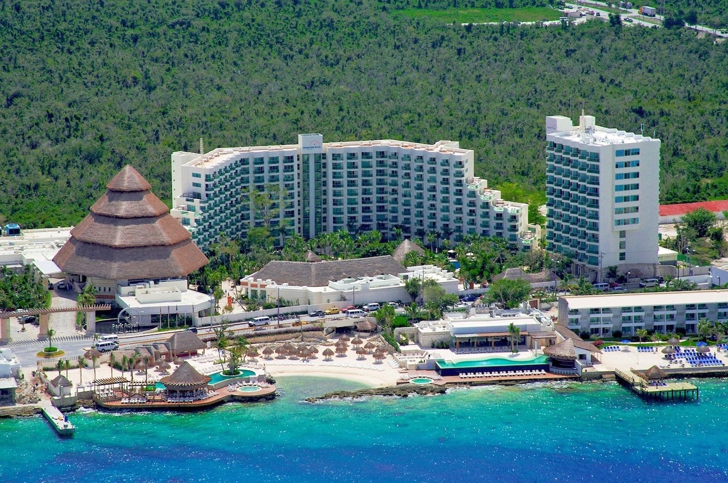 large beach resort between jungle and blue sea