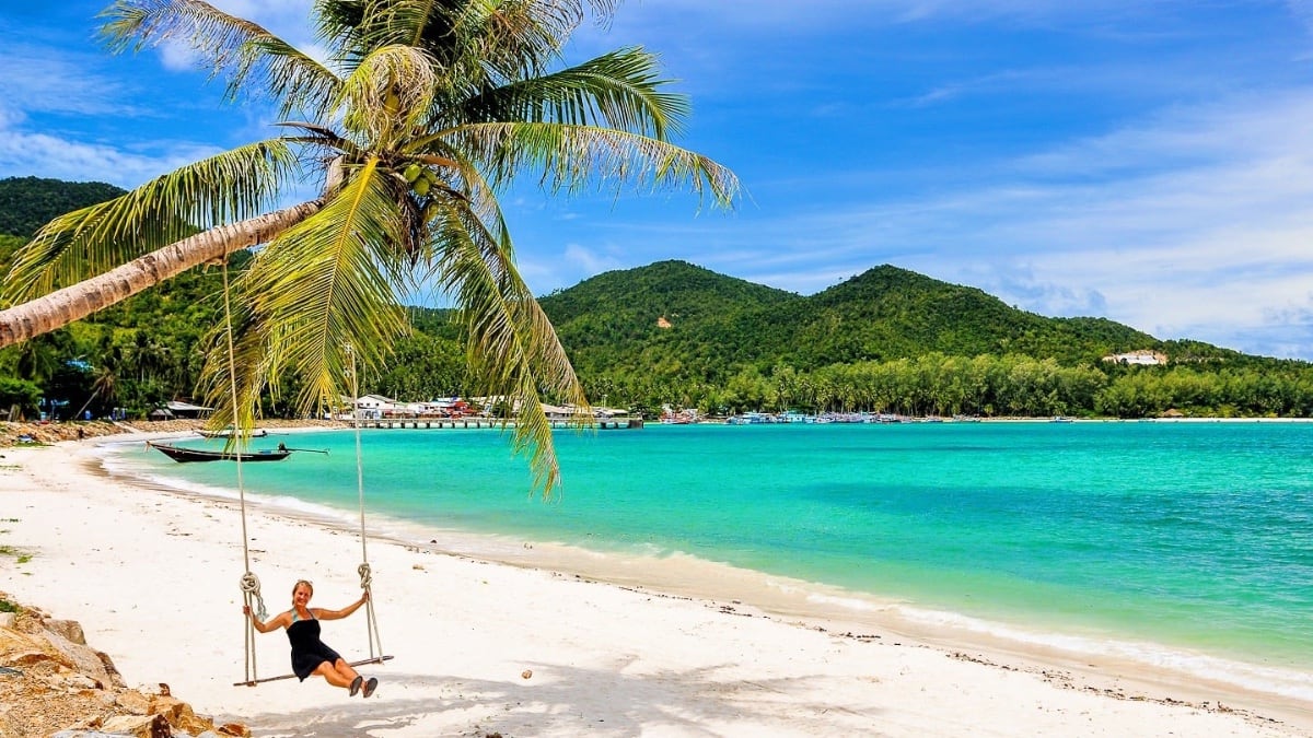 AwayGoWe newsletter signup woman swinging on tropical beach